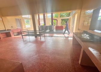 Image of newly renovated kitchen at St. Clare with a man walking in the background and sunlight is streaming through the windows